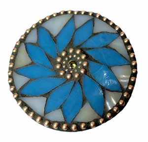 The mosaic materials are signatures of Joan's work. The petal colors are favorites. The brass beadchain, which is more commonly seen hanging from fans and lights to turn the fixtures on or off, is an element you see in almost all of Joan's mosaics. Newer to the scene is the bling -- cubic zirconia -- which she can't get enough of. 