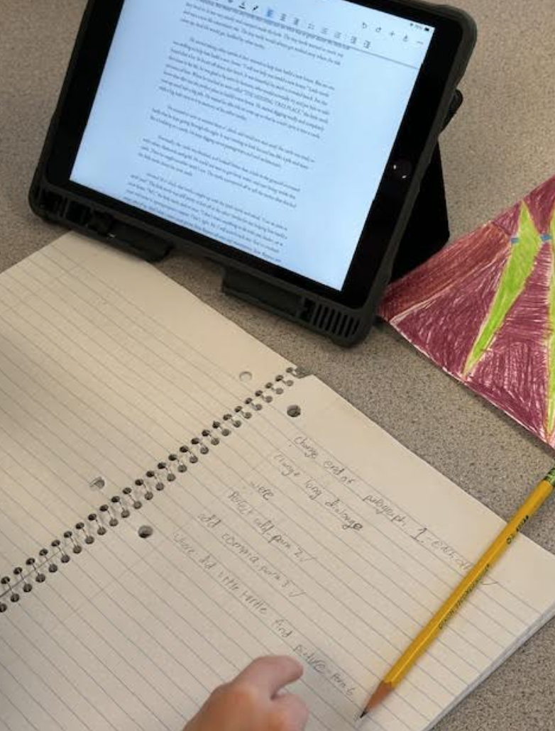 Photo of a student notebook next to an iPad