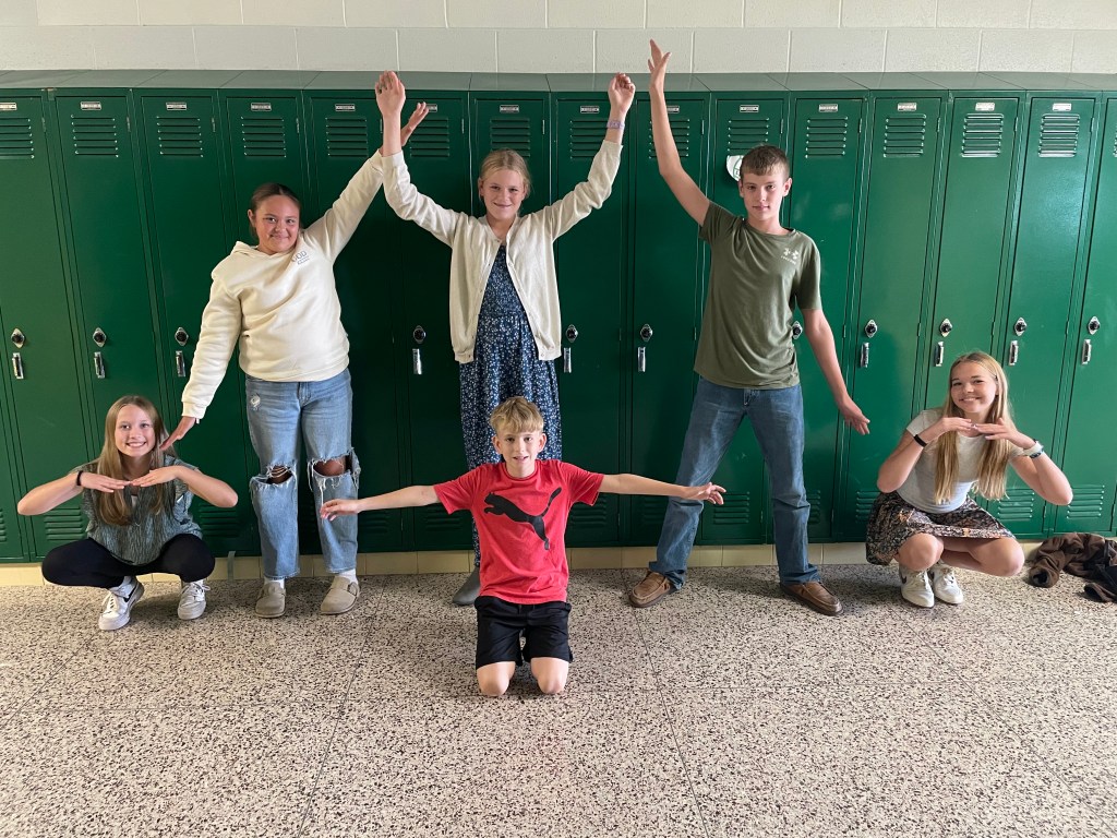 Students stand in formations representing the elements of plot within a story.